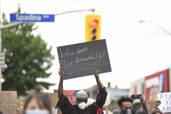 protest with sign that reads: police accountability